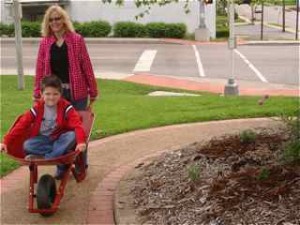 The day wasn't all work. Tina gives Ryan a ride in the wheelbarrow that she won in the drawing.