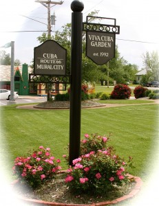 The pink knockout roses surround the Garden's sign.
