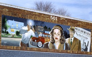 The mural commemorating Bette Davis's visits draws many tourists to continue to take her photograph.