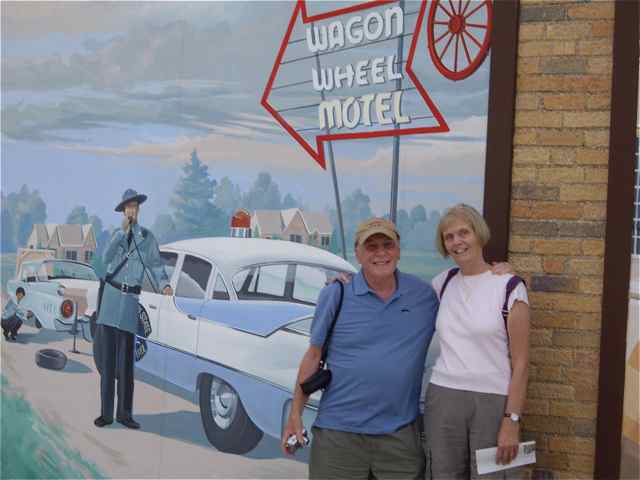 These visitors from Hampshire, England pose in from of the Wagon Wheel sign on the Bill Wallis History at the 4-Way.