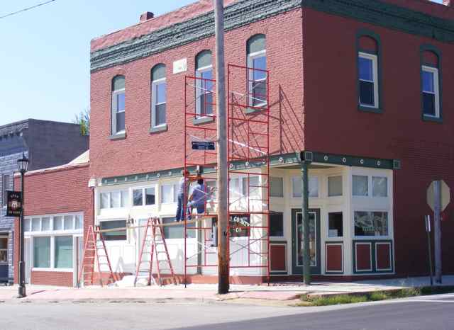 Painters on scaffolding transformed the old building.