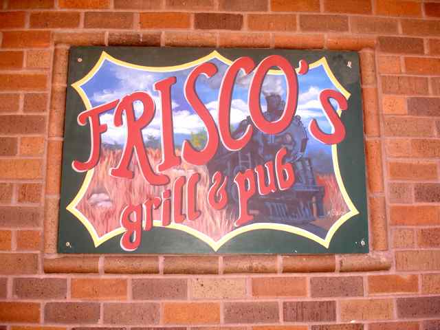 Frisco's Grill & Pub mural-style sign features the restaurant's relationship with the railroad.
