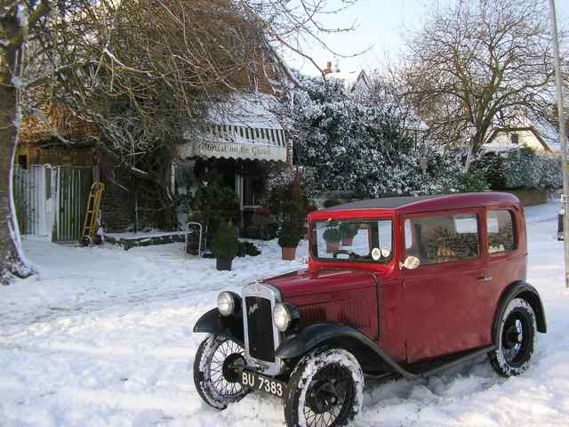 A vintage Austin 7 and a little snow brings a Christmas card like image to Cuba, MO.