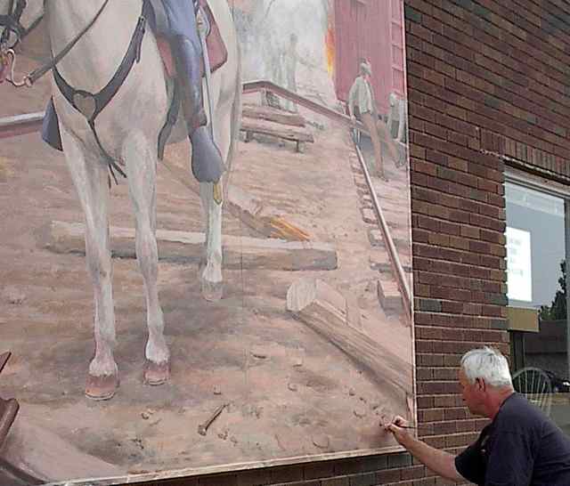 Artist Don Gray is signing the mural that changed the face of Buchanan St. 