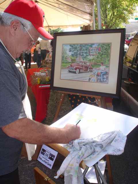 Joe Squires worked on a painting while at the Cuba Fest.