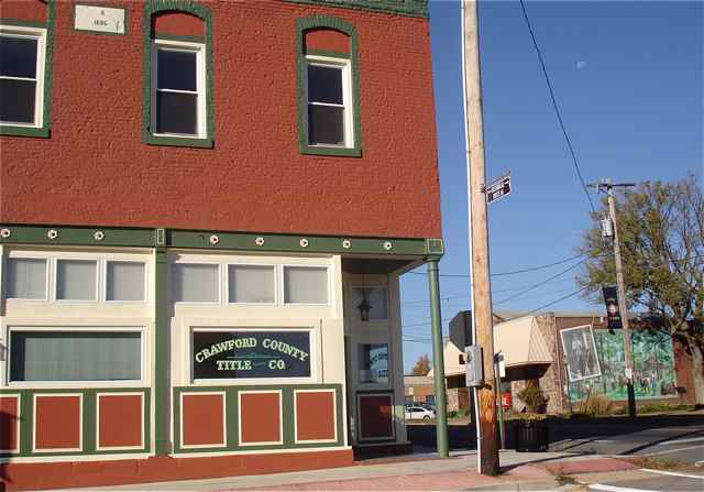 This 1886 building has been restored and houses the Crawford County Title Company. Its distinctive corner entrance can be seen in the A.J. Barnett Model T mural.