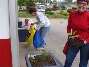 Alice Grogan and Patty Elders are planting, but Jill thinks she sees more trash. 