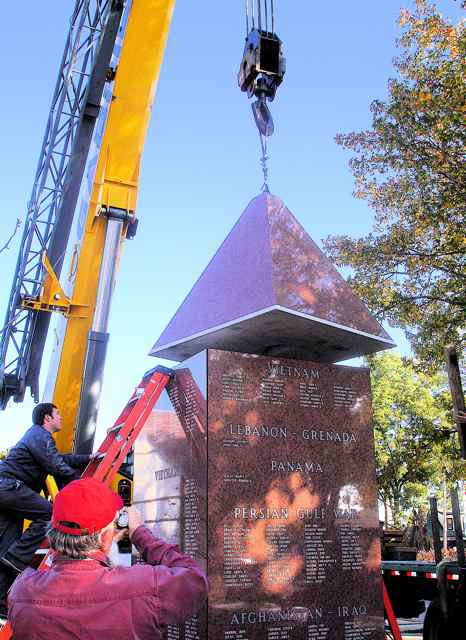 A crane and workman carefully erected the Veterans Memorial.