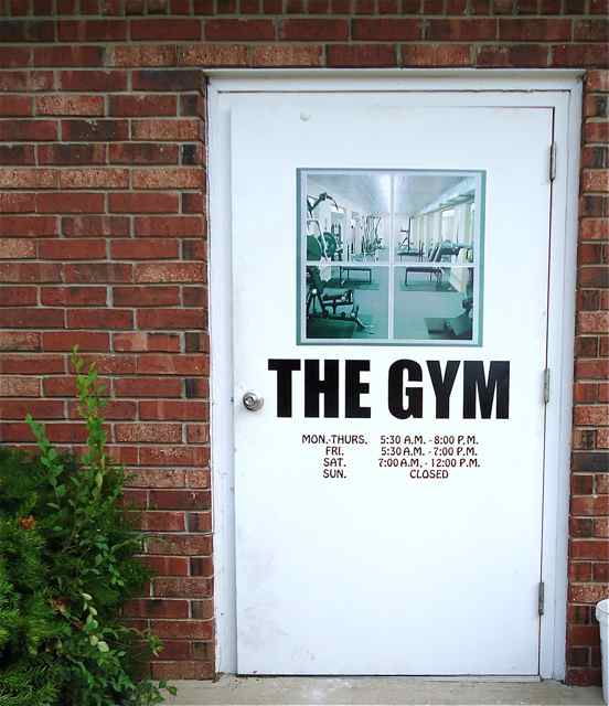 The Gym's hours are posted on their new door.